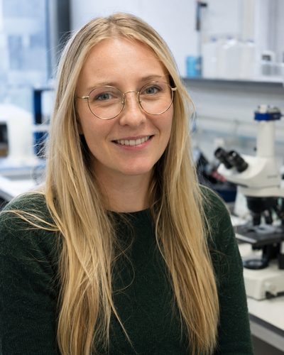 Hannah Cooper, statistics specialist, working at her desk